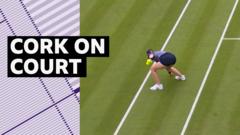wimbledon:-ball-girl-removes-champagne-cork-from-court